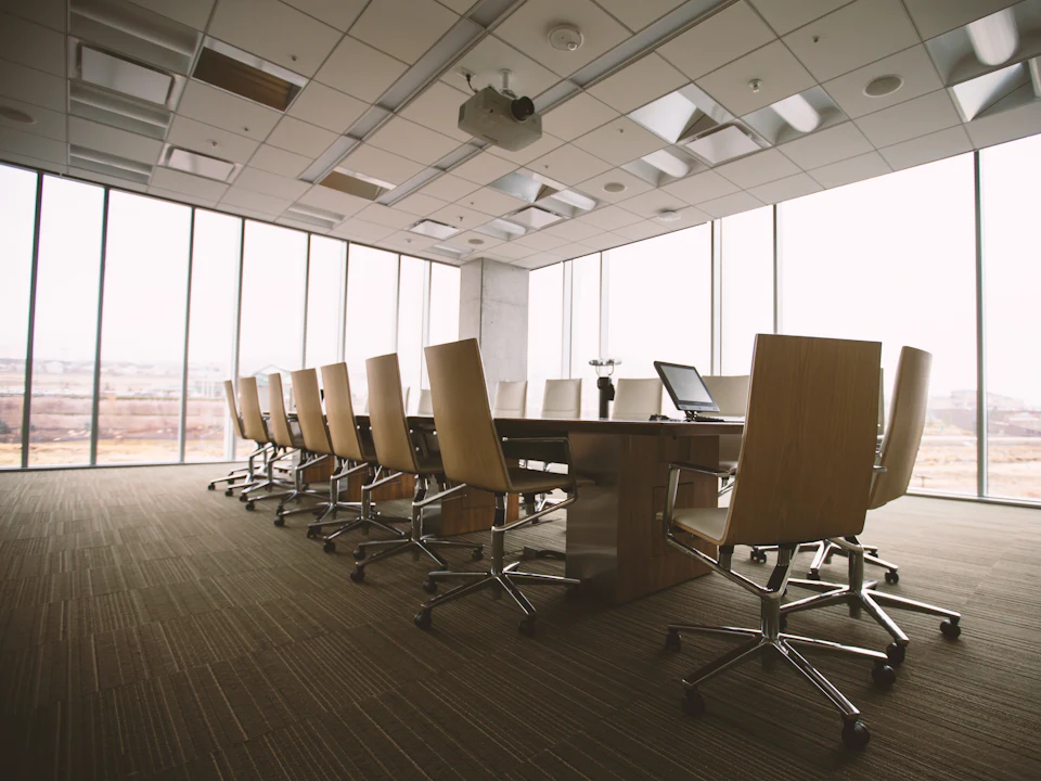 Executive boardroom with leather chairs and floor-to-ceiling windows